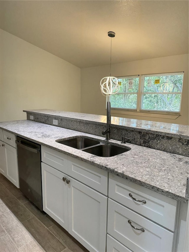 kitchen with a sink, white cabinetry, black dishwasher, light stone countertops, and pendant lighting