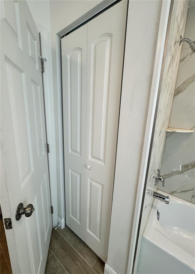 full bathroom featuring shower / bathtub combination, a closet, and wood tiled floor