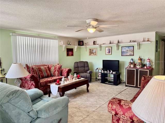 living room featuring ceiling fan, carpet floors, and a textured ceiling