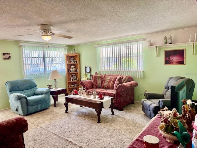 carpeted living room with ceiling fan and a textured ceiling