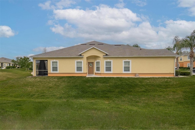 view of front of home featuring a sunroom and a front lawn