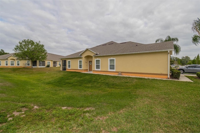 rear view of property with a yard