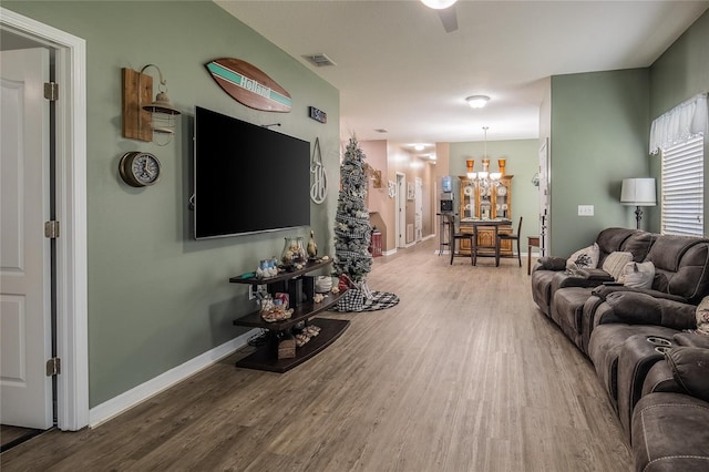 living room with a notable chandelier and wood-type flooring