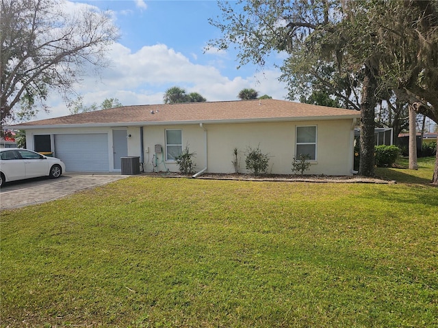 ranch-style home featuring a garage, a front lawn, and central air condition unit