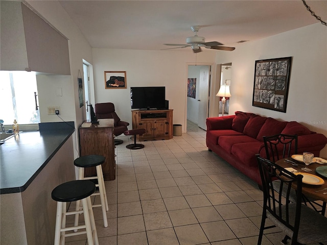 tiled living room featuring ceiling fan