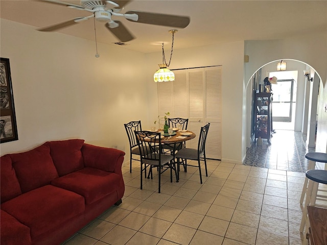 dining space featuring light tile patterned flooring and ceiling fan