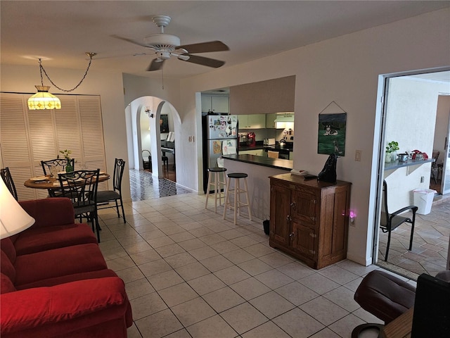 living room featuring ceiling fan and light tile patterned floors