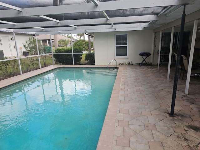 view of pool featuring a lanai and a patio area