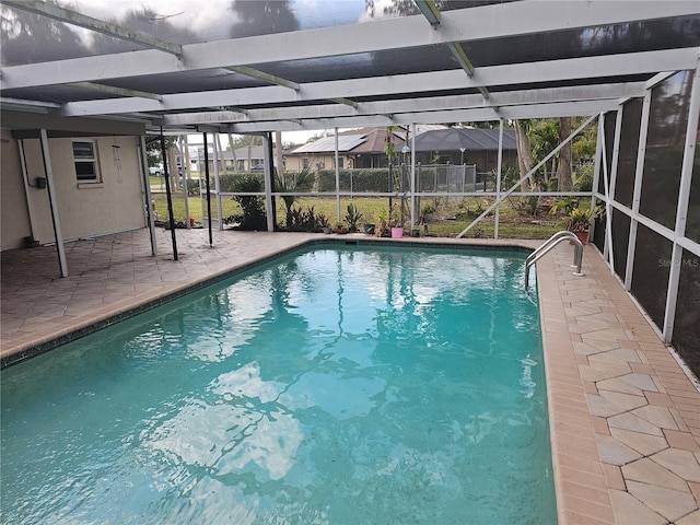 view of pool with a patio and glass enclosure