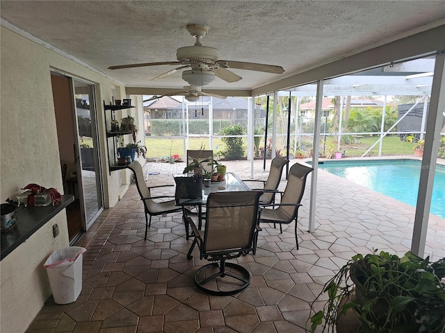 sunroom featuring ceiling fan