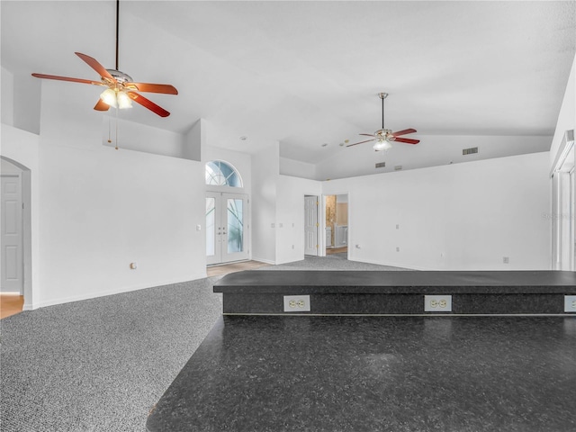 unfurnished living room featuring ceiling fan, high vaulted ceiling, french doors, and visible vents