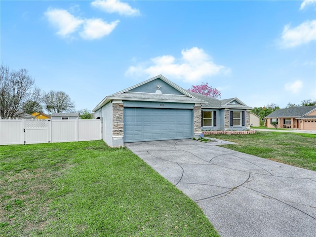 single story home featuring an attached garage, concrete driveway, a front lawn, and stone siding