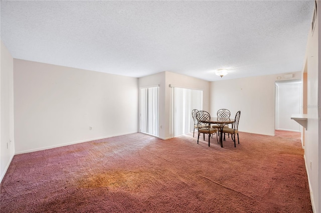 carpeted dining area with a textured ceiling