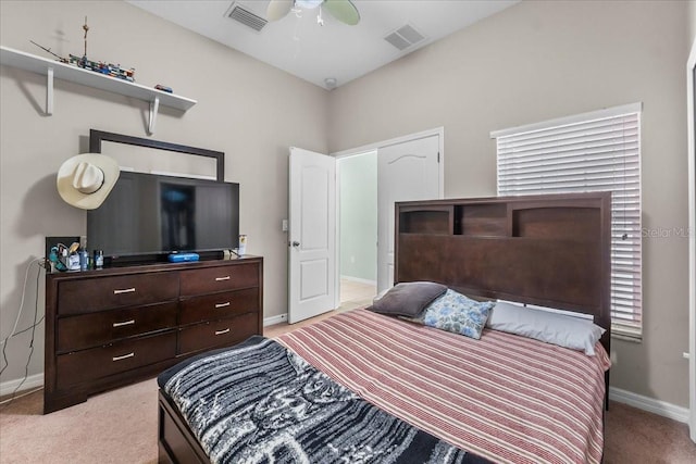 bedroom with light carpet, ceiling fan, visible vents, and baseboards