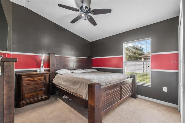 bedroom featuring light carpet, baseboards, a ceiling fan, and lofted ceiling