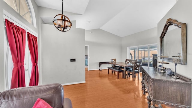 interior space featuring hardwood / wood-style floors, a notable chandelier, and high vaulted ceiling