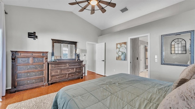 bedroom with vaulted ceiling, light hardwood / wood-style floors, and ceiling fan