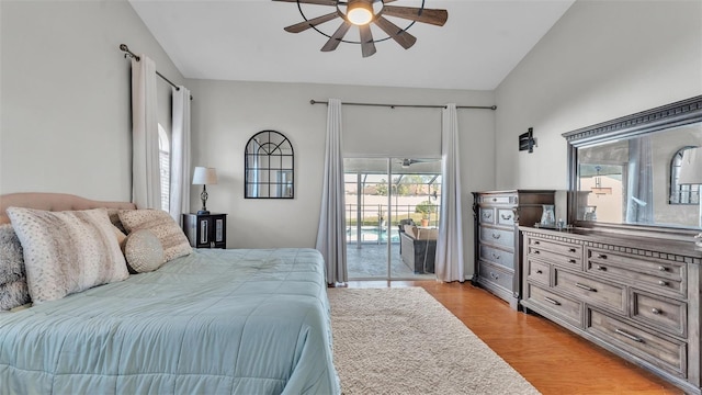 bedroom featuring ceiling fan, lofted ceiling, light hardwood / wood-style flooring, and access to outside