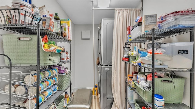 storage area featuring stacked washing maching and dryer