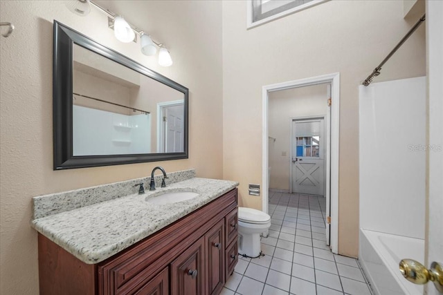 full bathroom with tile patterned flooring, vanity, tub / shower combination, and toilet