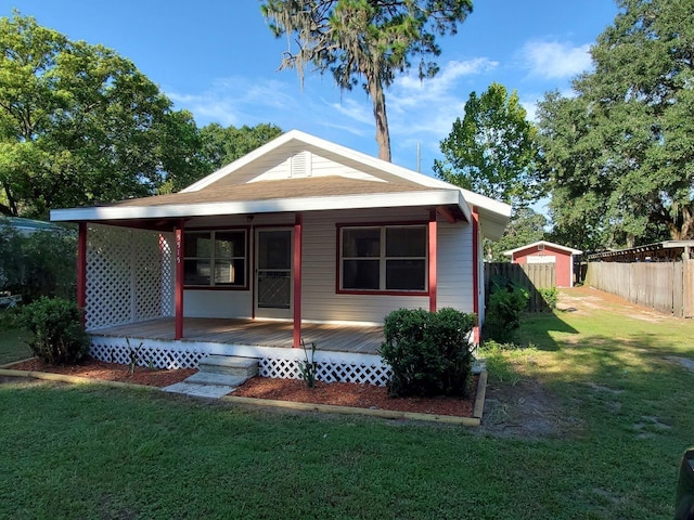 back of house featuring a yard and a deck