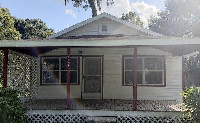 rear view of house featuring a deck