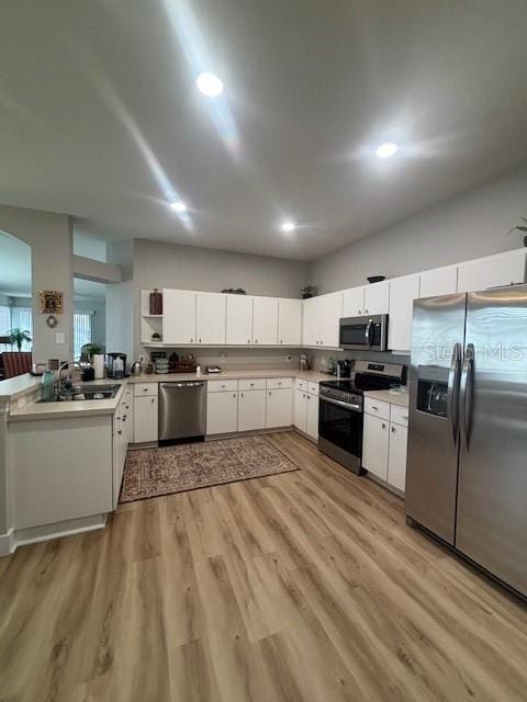 8623 Snowy Owl Way, Tampa, FL 33647 - kitchen with open shelves, a sink, light countertops, stainless steel appliances, and light wood-style flooring