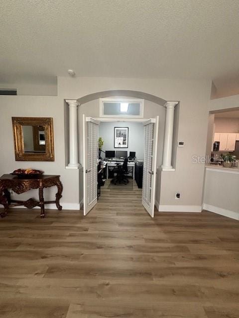 8623 Snowy Owl Way, Tampa, FL 33647 - hallway featuring ornate columns, baseboards, and arched walkways