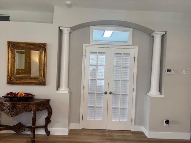 8623 Snowy Owl Way, Tampa, FL 33647 - entryway with baseboards, arched walkways, ornate columns, wood finished floors, and french doors