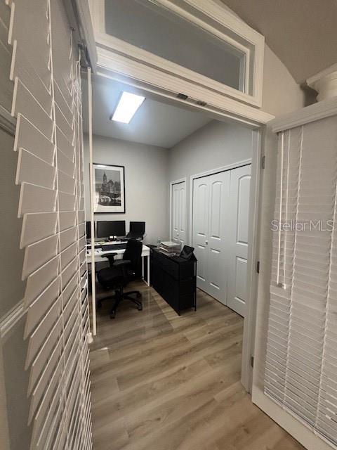 8623 Snowy Owl Way, Tampa, FL 33647 - home office featuring light wood-style flooring and vaulted ceiling