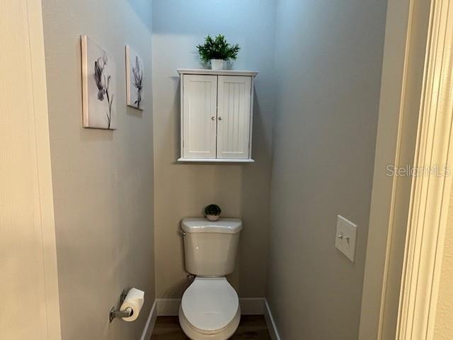 8623 Snowy Owl Way, Tampa, FL 33647 - bathroom featuring baseboards and toilet