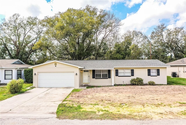 ranch-style home with cooling unit and a garage