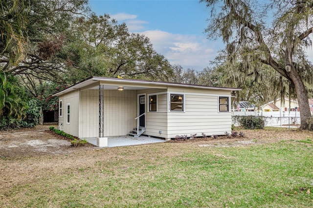 back of property featuring a yard