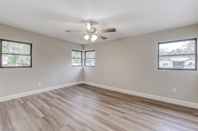 spare room featuring light wood-type flooring and ceiling fan