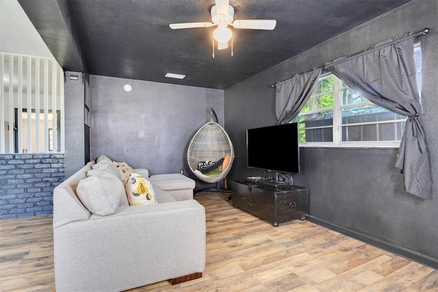 living room with ceiling fan and light wood-type flooring