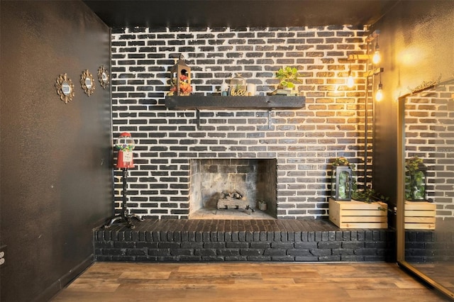 details featuring a brick fireplace and hardwood / wood-style floors