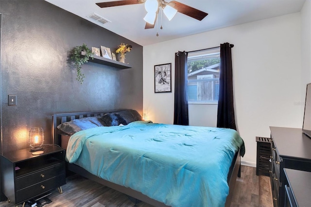 bedroom featuring dark wood-type flooring and ceiling fan