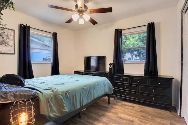 bedroom with ceiling fan and light hardwood / wood-style floors