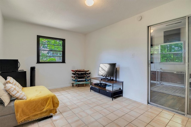 bedroom with light tile patterned flooring and a textured ceiling