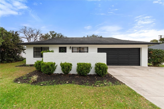 ranch-style house featuring a garage and a front yard