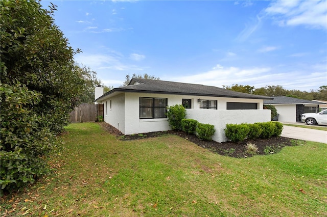 view of front of house featuring a garage and a front lawn