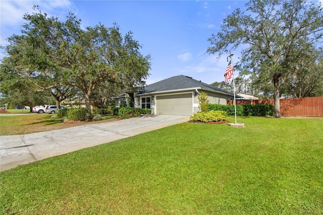 ranch-style house featuring fence, concrete driveway, a front yard, stucco siding, and an attached garage