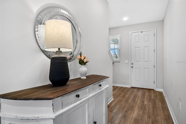 foyer with recessed lighting, baseboards, and dark wood finished floors