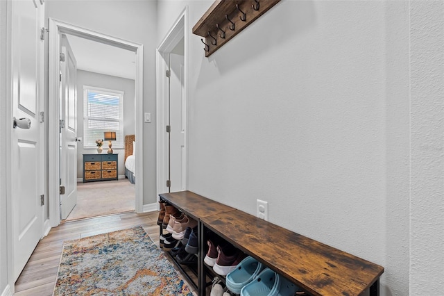 mudroom with light wood-style flooring