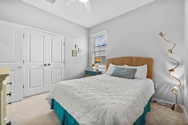 carpeted bedroom featuring a closet, baseboards, and a ceiling fan