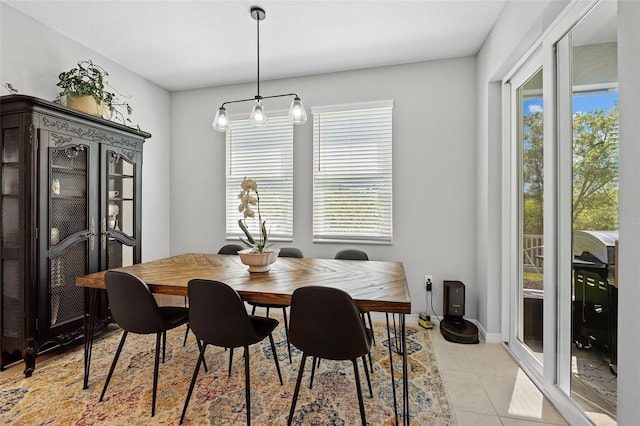 dining area featuring light tile patterned floors and baseboards