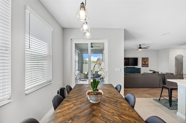 dining space with visible vents, arched walkways, and a ceiling fan