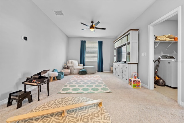 recreation room with visible vents, baseboards, light carpet, washer / dryer, and a ceiling fan