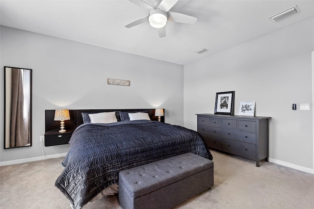 bedroom featuring visible vents, baseboards, light colored carpet, and ceiling fan