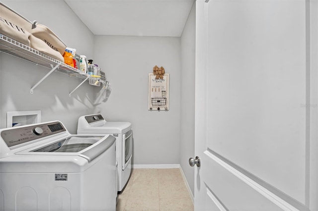 washroom with laundry area, baseboards, and separate washer and dryer